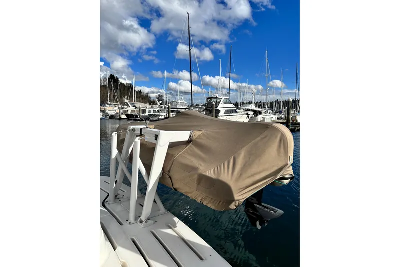  Yacht Photos Pics Covered boat on a dock, surrounded by sailboats, under a blue sky. Meridian 411 Sedan, 2004.