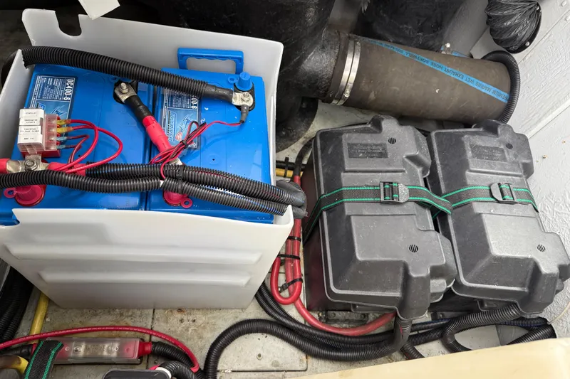  Yacht Photos Pics Battery compartment of a 2004 Meridian 411 Sedan, featuring wiring and protective casings.