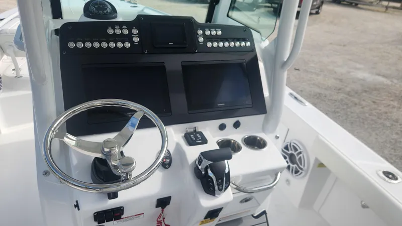  Yacht Photos Pics 2025 Everglades 253 Center Console boat dashboard with steering wheel and control panel.