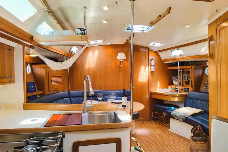 Alola Yacht Photos Pics Interior of 2003 Catalina 42 MkII sailboat with cozy seating and wooden finishes.