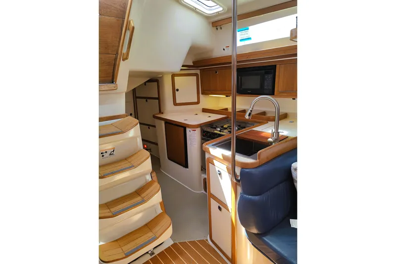 Alola Yacht Photos Pics Interior of 2003 Catalina 42 MkII sailboat with kitchen and seating area.