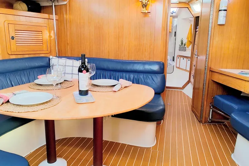 Alola Yacht Photos Pics Interior of 2003 Catalina 42 MkII yacht with dining area and wooden finish.