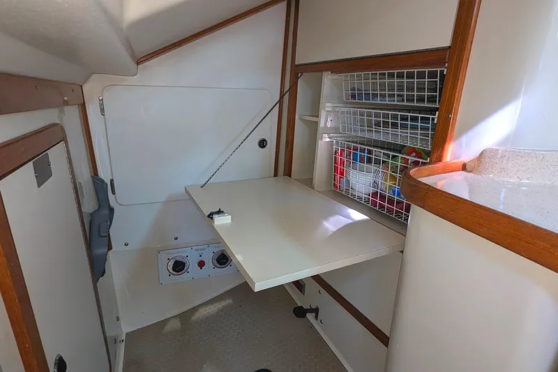 Alola Yacht Photos Pics 2003 Catalina 42 MkII interior with foldable table and storage shelves.