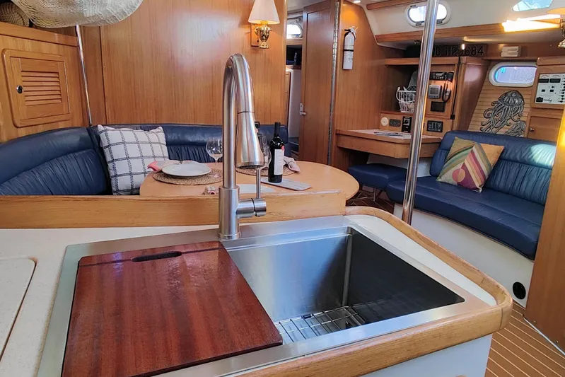 Alola Yacht Photos Pics Interior of 2003 Catalina 42 MkII sailboat with modern kitchen and cozy seating area.