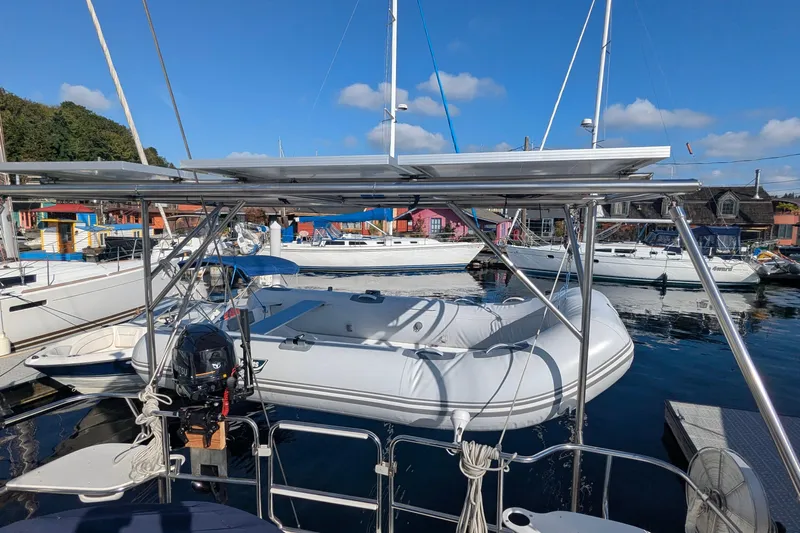 Alola Yacht Photos Pics Sailboats docked at marina, featuring a 2003 Catalina 42 MkII with solar panels and inflatable dinghy.