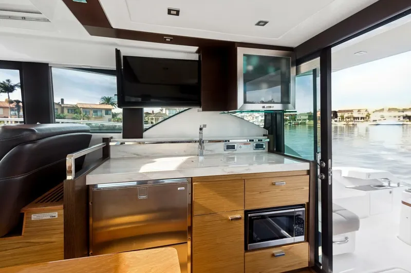 Pour It On Yacht Photos Pics Interior of 2017 Tiara Yachts C39 Coupe with modern kitchen and waterfront view.