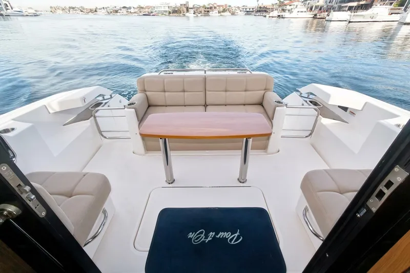 Pour It On Yacht Photos Pics 2017 Tiara Yachts C39 Coupe cockpit with seating and table, overlooking serene waters.