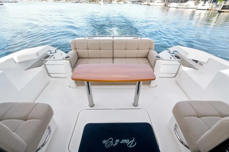 Pour It On Yacht Photos Pics 2017 Tiara Yachts C39 Coupe cockpit with seating and table, overlooking serene water.