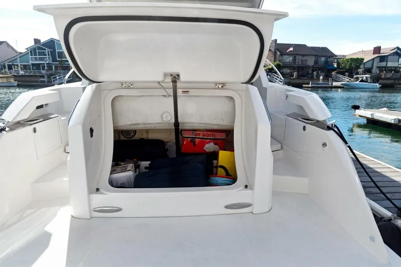 Pour It On Yacht Photos Pics 2017 Tiara Yachts C39 Coupe storage compartment with life jackets and equipment, dockside view.