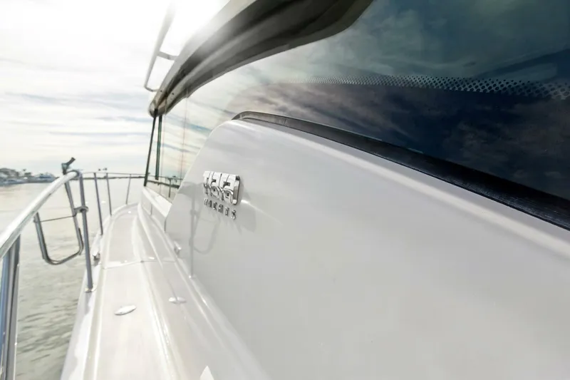 Pour It On Yacht Photos Pics 2017 Tiara Yachts C39 Coupe, sleek design, side view with logo, sunny day on water.