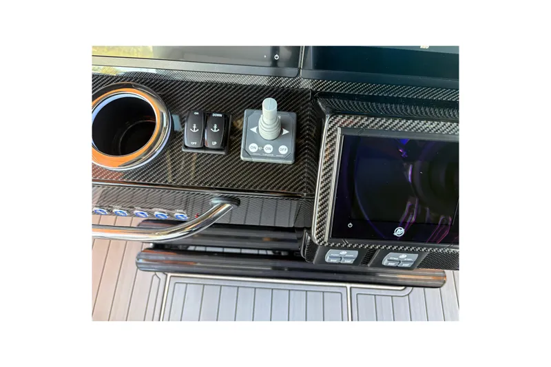  Yacht Photos Pics 2024 Nor-Tech 400 Supersport dashboard with carbon fiber finish and modern controls.