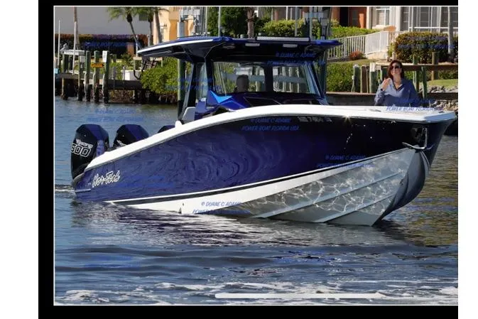  Yacht Photos Pics 2024 Nor-Tech 400 Supersport boat cruising on water, featuring sleek blue design and powerful engines.