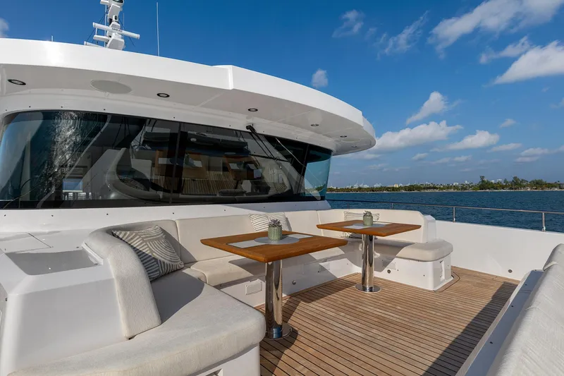 Rocket One Yacht Photos Pics Luxurious Gulf Craft Majesty 120 yacht deck with seating, tables, and ocean view, 2022 model.