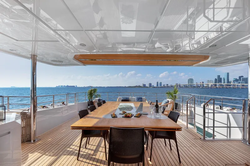 Rocket One Yacht Photos Pics Luxurious outdoor dining area on 2022 Gulf Craft Majesty 120 yacht with ocean and city views.