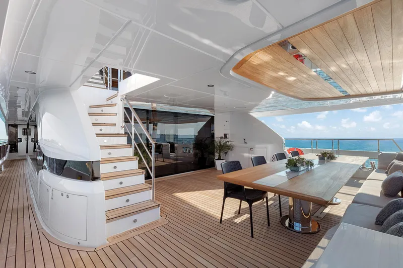 Rocket One Yacht Photos Pics Luxurious 2022 Gulf Craft Majesty 120 yacht deck with elegant dining area and ocean view.
