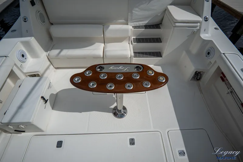 Legacy Yacht Photos Pics 2003 Tiara Yachts 4200 Open cockpit with seating and a wooden table.