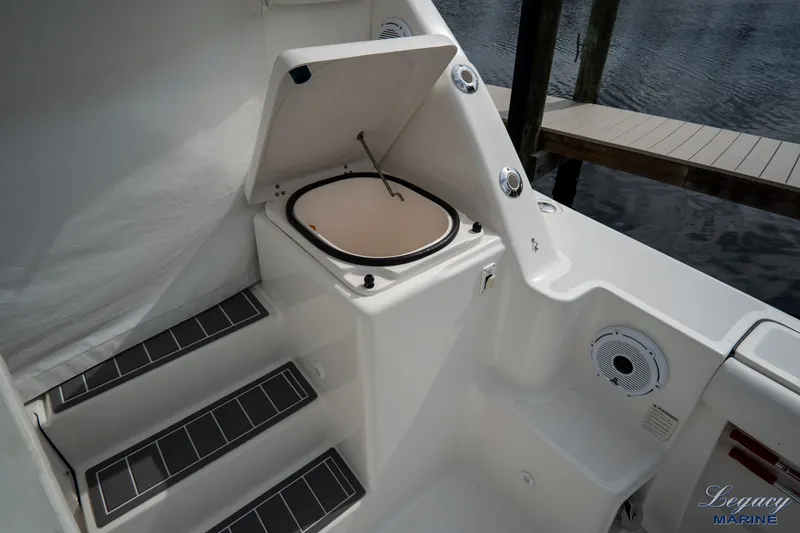 Legacy Yacht Photos Pics 2003 Tiara Yachts 4200 Open boat interior with open storage compartment and steps.
