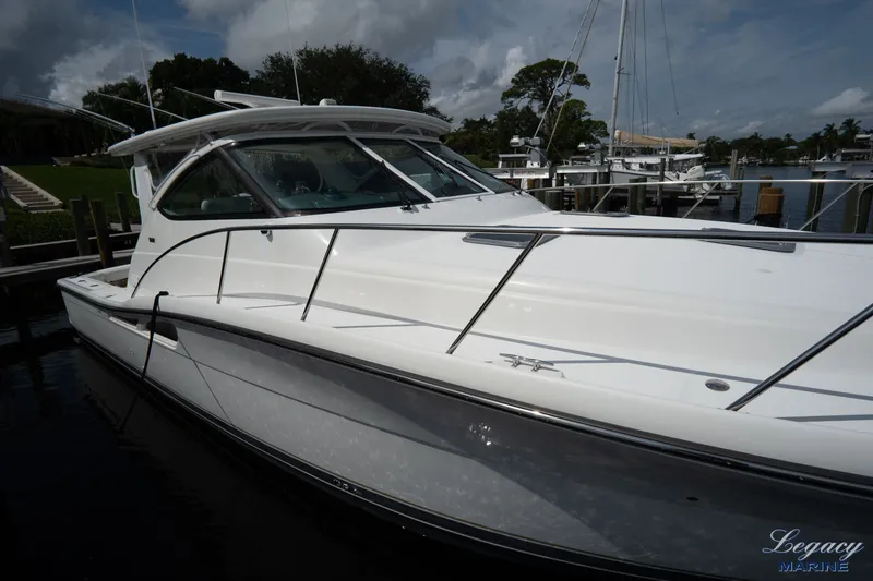 Legacy Yacht Photos Pics 2003 Tiara Yachts 4200 Open docked, showcasing sleek design and polished white exterior.