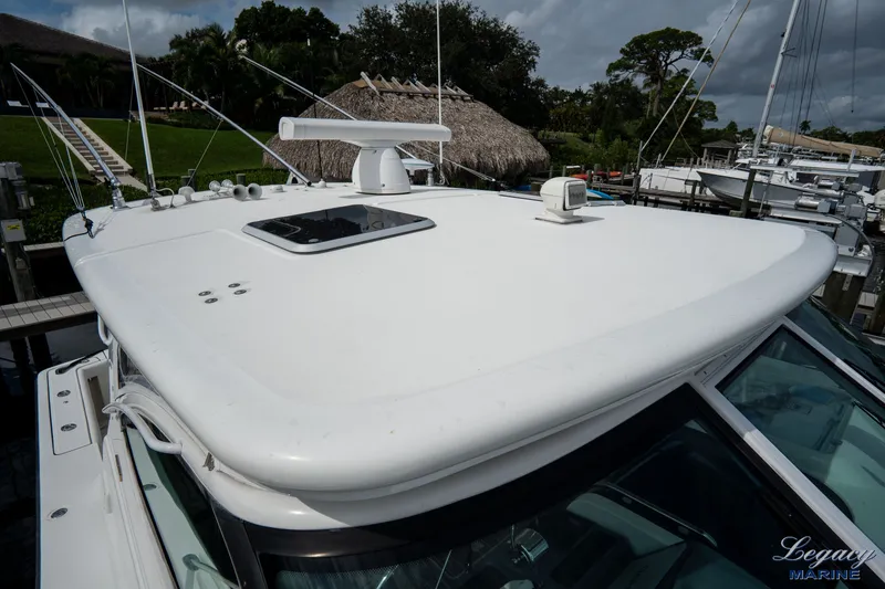 Legacy Yacht Photos Pics 2003 Tiara Yachts 4200 Open boat roof with radar, docked in marina.