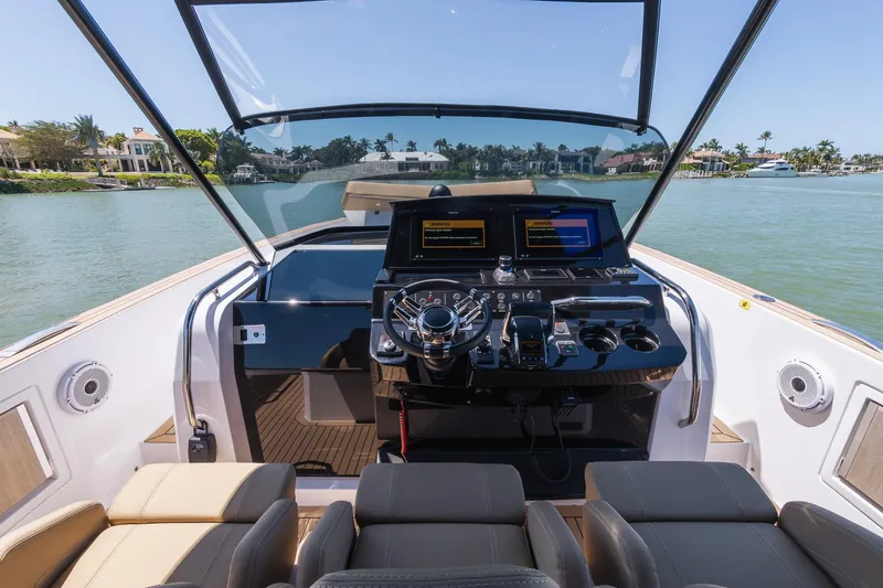  Yacht Photos Pics Helm of 2025 Pardo Yachts 38, featuring modern controls and luxurious seating on a sunny day.