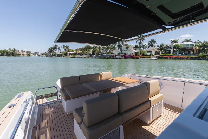  Yacht Photos Pics 2025 Pardo Yachts 38 with elegant seating, shaded deck, and scenic waterfront view.