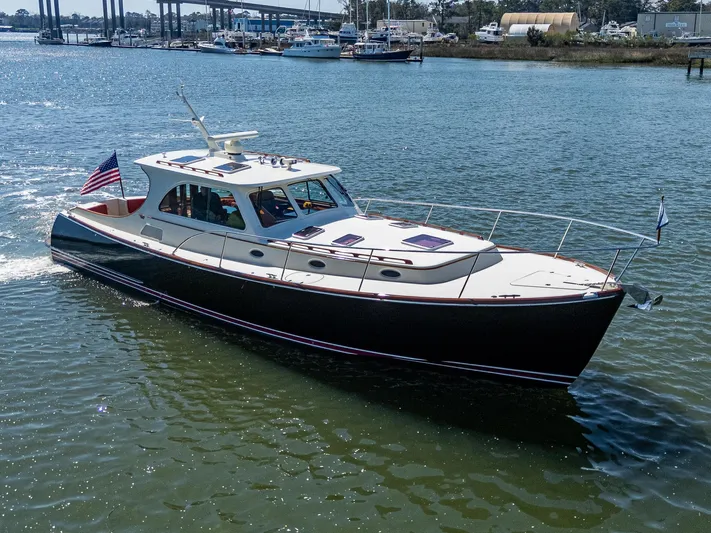 Double Expresso Yacht Photos Pics 2006 Hinckley Talaria 44 MY yacht cruising on a sunny day in a marina.