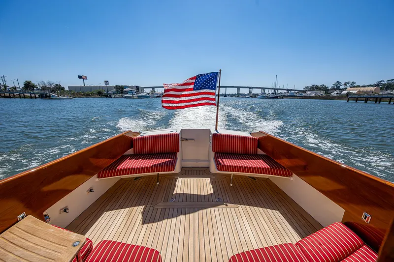 Double Expresso Yacht Photos Pics Hinckley Talaria 44 MY 2006 yacht with American flag, cruising on a sunny day.