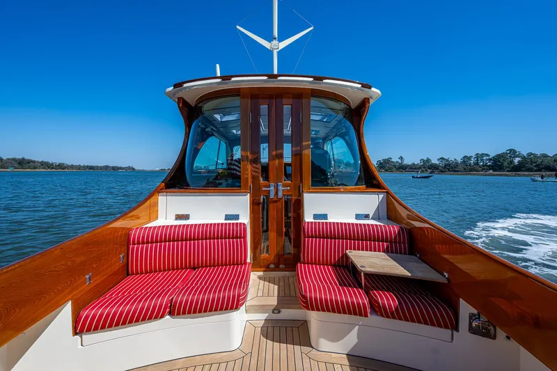 Double Expresso Yacht Photos Pics 2006 Hinckley Talaria 44 MY yacht with red-striped seating on a sunny day.