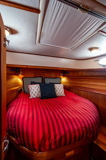 Double Expresso Yacht Photos Pics Luxurious cabin interior of 2006 Hinckley Talaria 44 MY with red-striped bedding.