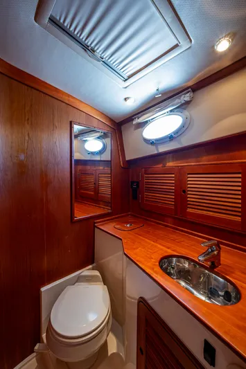 Double Expresso Yacht Photos Pics Luxury bathroom interior of 2006 Hinckley Talaria 44 MY yacht with wood accents and modern fixtures.