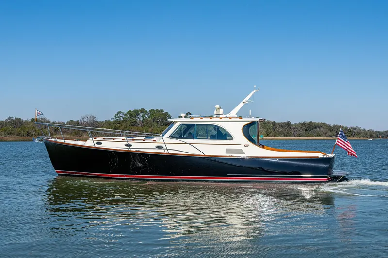 Double Expresso Yacht Photos Pics 2006 Hinckley Talaria 44 MY yacht cruising on calm waters under clear blue skies.