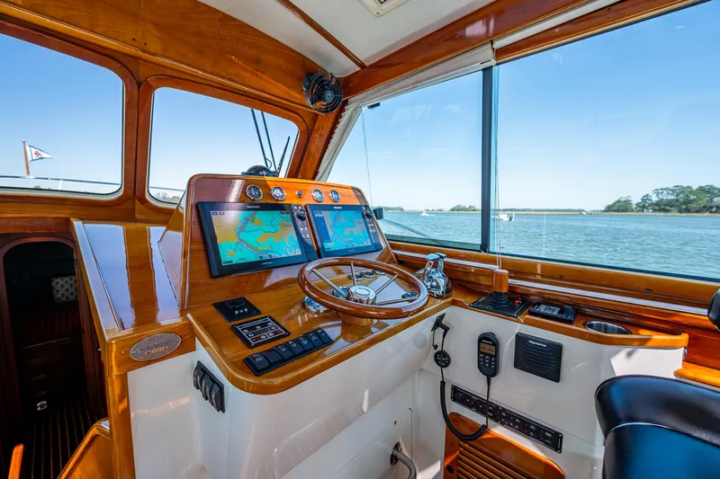 Double Expresso Yacht Photos Pics Helm of 2006 Hinckley Talaria 44 MY with navigation screens and wooden steering wheel.