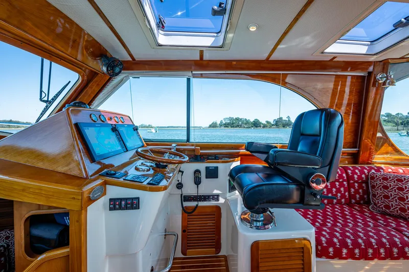 Double Expresso Yacht Photos Pics Interior of 2006 Hinckley Talaria 44 MY yacht with helm, leather chair, and scenic window view.