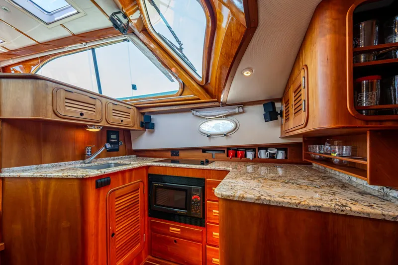 Double Expresso Yacht Photos Pics Luxurious 2006 Hinckley Talaria 44 MY yacht interior with elegant wood cabinetry and granite countertops.
