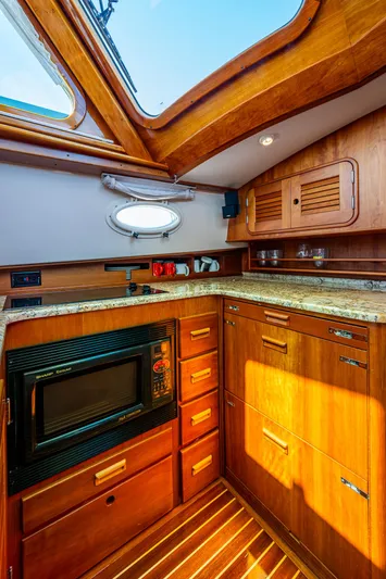 Double Expresso Yacht Photos Pics 2006 Hinckley Talaria 44 MY yacht kitchen with wooden cabinetry and skylight.