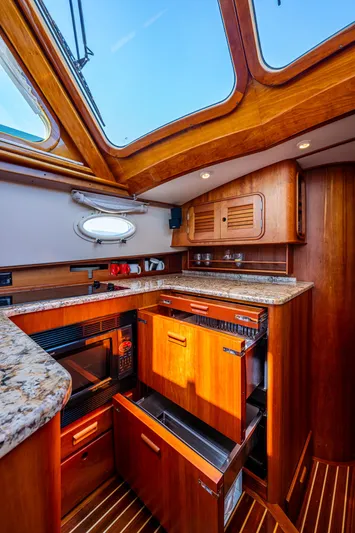 Double Expresso Yacht Photos Pics Luxurious 2006 Hinckley Talaria 44 MY yacht kitchen with wood cabinetry and granite countertops.
