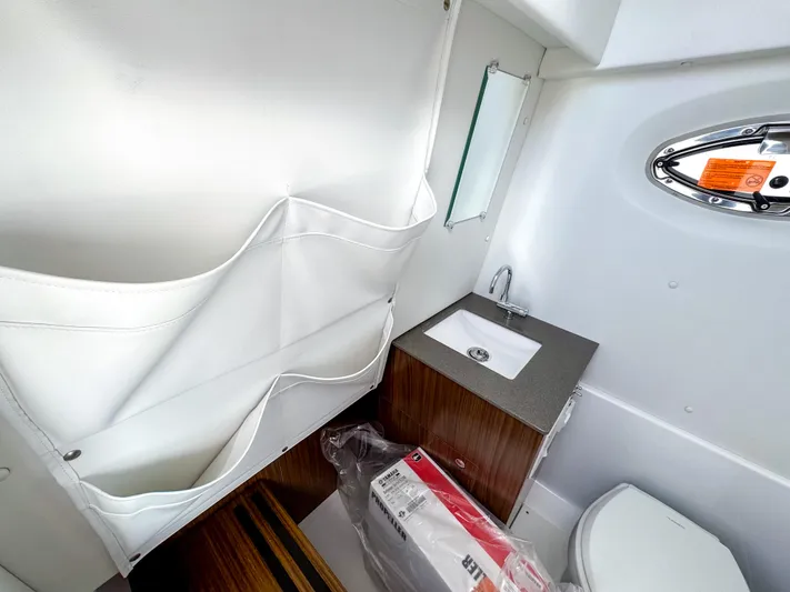  Yacht Photos Pics 2025 Wellcraft 302 Fisherman boat interior with sink, storage, and toilet.