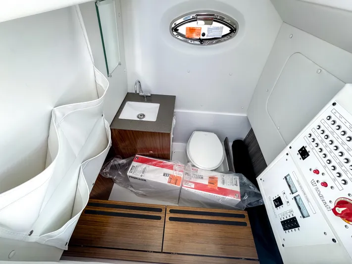  Yacht Photos Pics 2025 Wellcraft 302 Fisherman cabin with sink, toilet, and control panel.