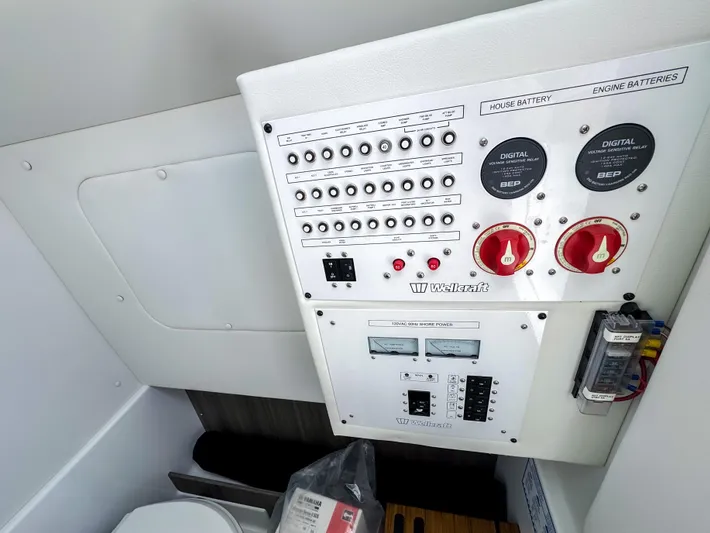  Yacht Photos Pics Control panel of 2025 Wellcraft 302 Fisherman boat, featuring switches and battery indicators.