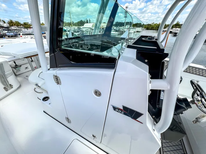  Yacht Photos Pics 2025 Wellcraft 302 Fisherman boat, sleek design, white exterior, docked at marina.