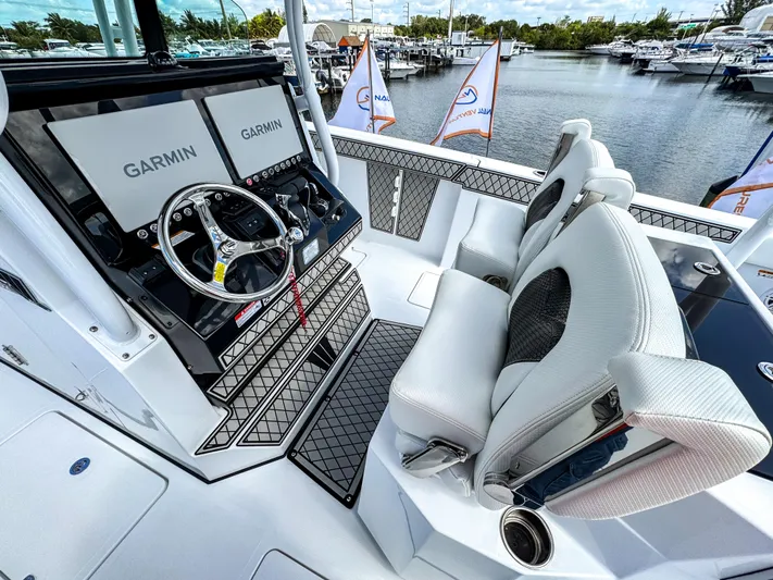  Yacht Photos Pics 2025 Wellcraft 302 Fisherman boat cockpit with Garmin displays and luxurious seating.