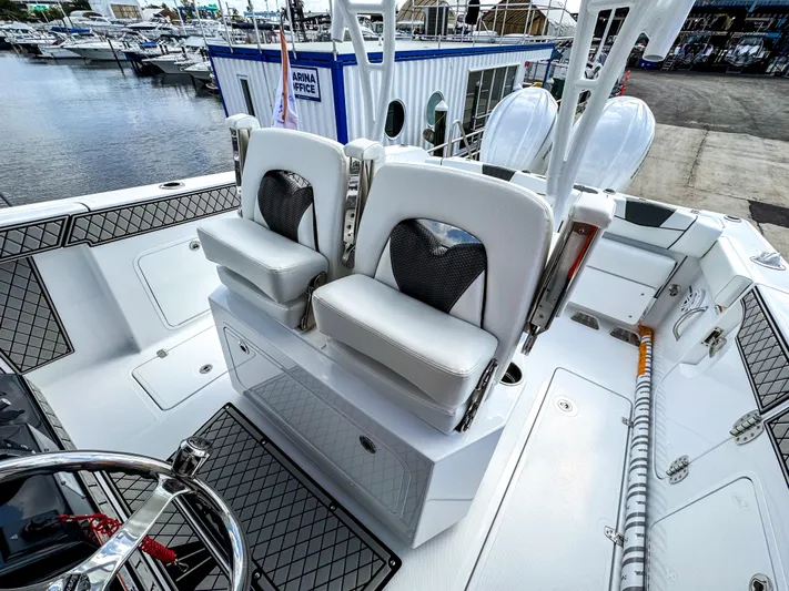  Yacht Photos Pics 2025 Wellcraft 302 Fisherman boat interior with dual white seats and marina view.