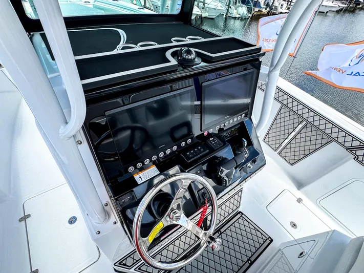  Yacht Photos Pics 2025 Wellcraft 302 Fisherman boat dashboard with steering wheel and control panel.