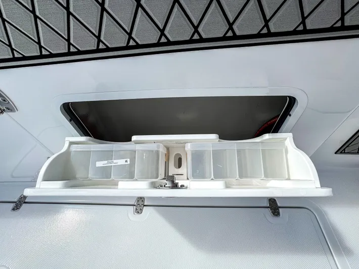  Yacht Photos Pics 2025 Wellcraft 302 Fisherman storage compartment with open lid and organized containers.