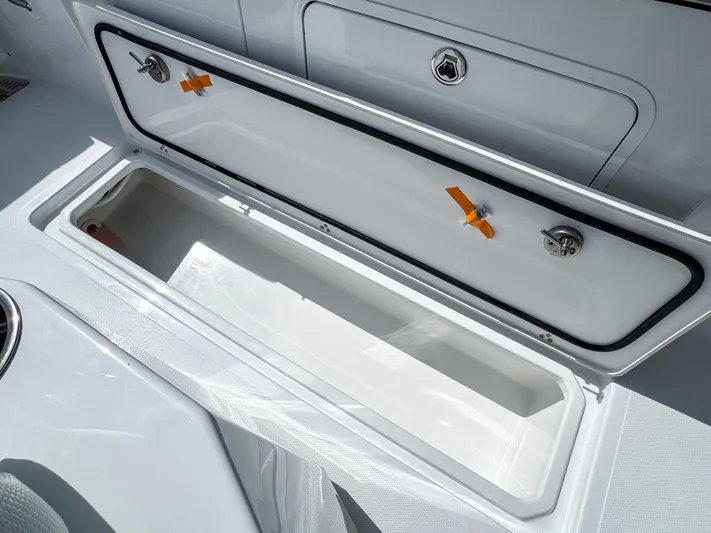  Yacht Photos Pics 2025 Wellcraft 302 Fisherman boat storage compartment, open and empty, showcasing sleek design.
