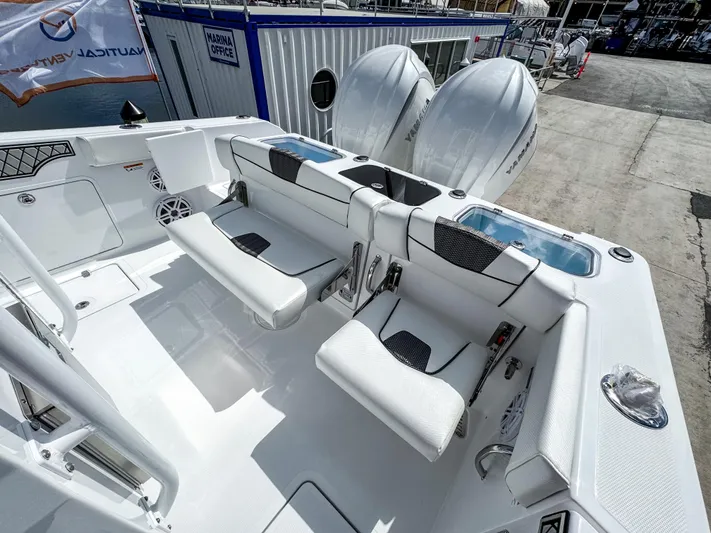  Yacht Photos Pics 2025 Wellcraft 302 Fisherman boat interior with white seating and dual outboard engines.