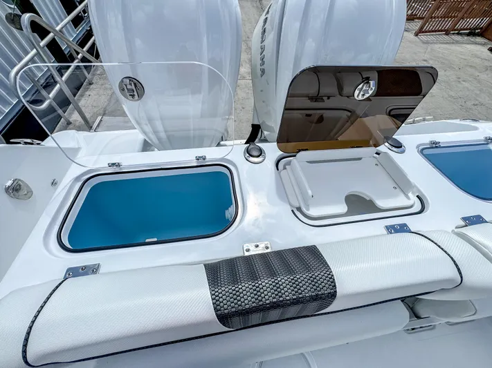  Yacht Photos Pics 2025 Wellcraft 302 Fisherman boat deck with storage compartments and seating.