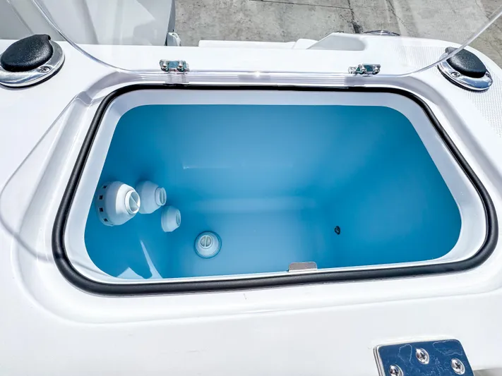  Yacht Photos Pics Livewell compartment on 2025 Wellcraft 302 Fisherman boat, featuring a sleek blue interior.