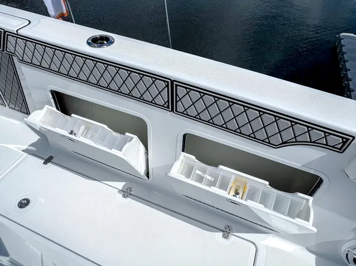  Yacht Photos Pics 2025 Wellcraft 302 Fisherman boat with open storage compartments on deck.