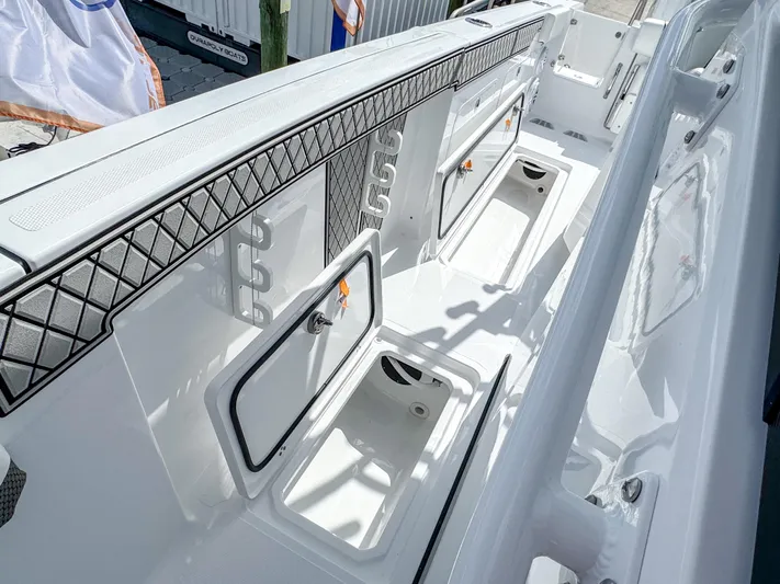  Yacht Photos Pics 2025 Wellcraft 302 Fisherman boat interior with storage compartments and sleek design.